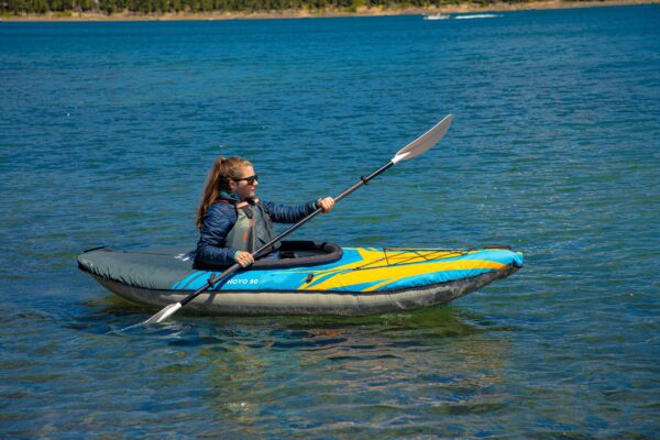 Aquia glide inflatable kayak on lake in forest background with mountains
