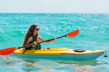 Girl testing stability in 1 seat pelican maxim kayak